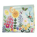 Gift bag with colorful floral design and happy face flowers on a light blue background