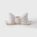 White ceramic bow-shaped object on a light gray background