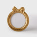 Gold decorative round picture frame with a bow on a white background