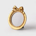 Gold picture frame with a bow design on a white background