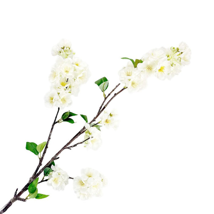 Artificial white cherry blossom branch on a white background