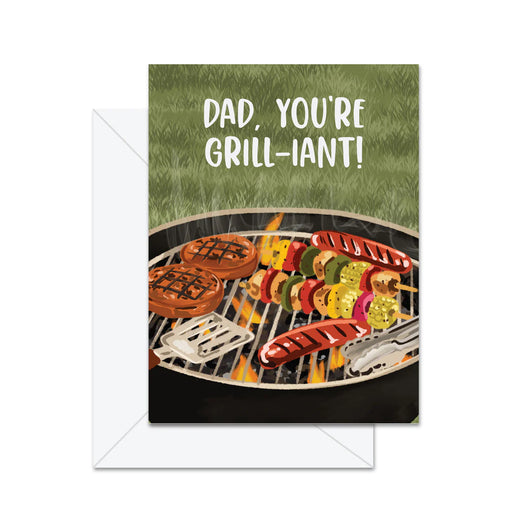 Greeting card with a grill scene and text 'Dad, you're grill-iant!' on a grass background.