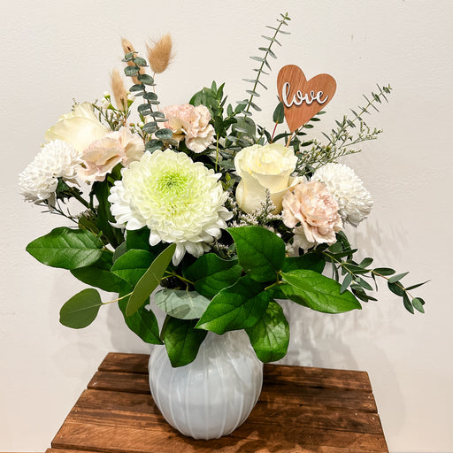 Soft and Muted floral Tones with greenery designed in a white vase