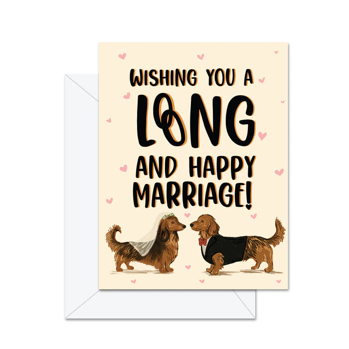 Greeting card with two dogs in wedding attire and text 'Wishing you a long and happy marriage!' on a beige background.