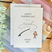 Father's Day card with fishing theme on a decorative table with scissors and flowers.