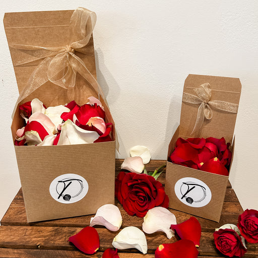 Gift box filled with rose petals 