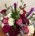 Floral design of purple passion combined with whites and greens