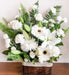 Basket flower arrangement of blended whites and greens